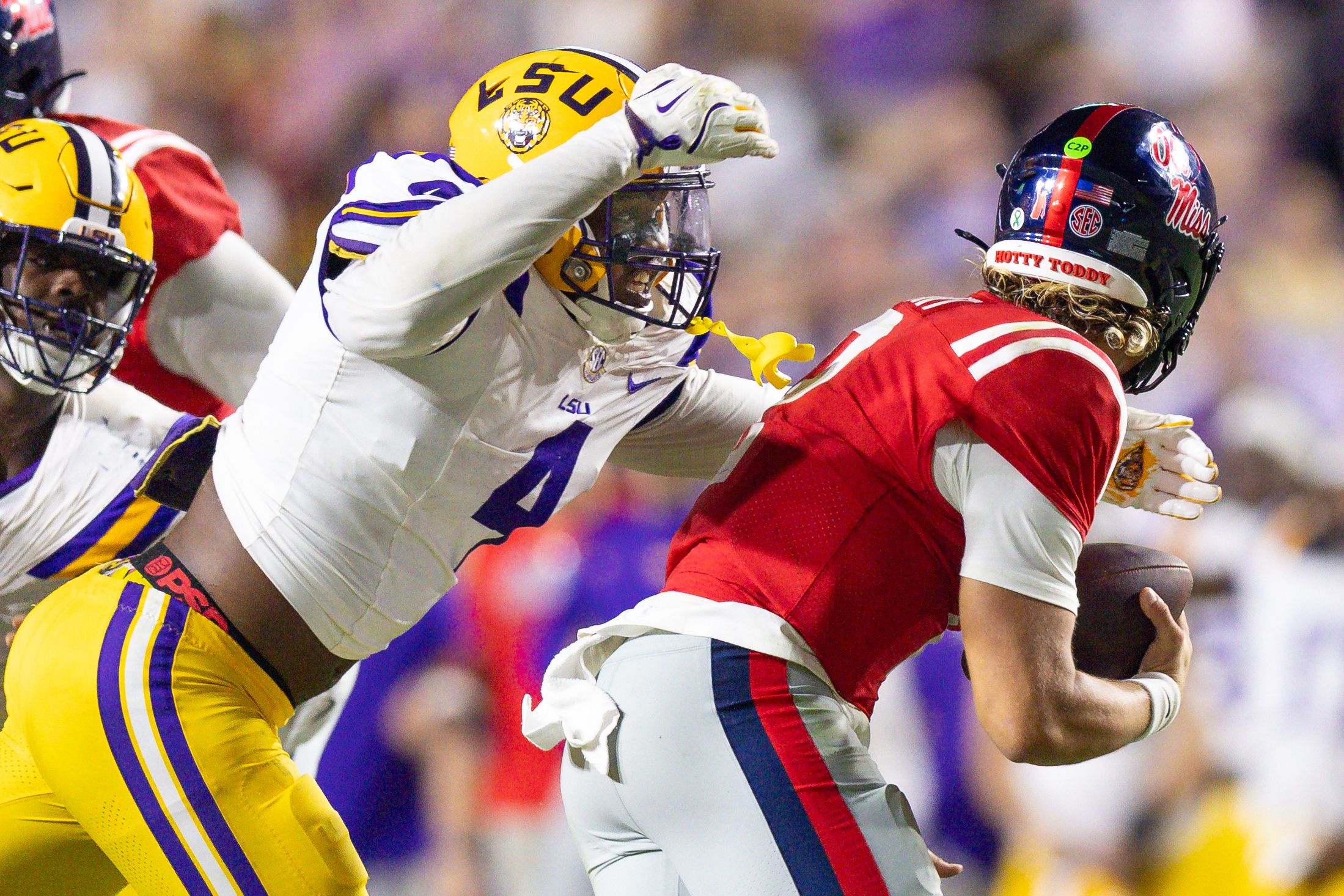 LSU Tigers defensive end Bradyn Swinson (4) sacks Mississippi Rebels quarterback Jaxson Dart (2) during the second half at Tiger Stadium.