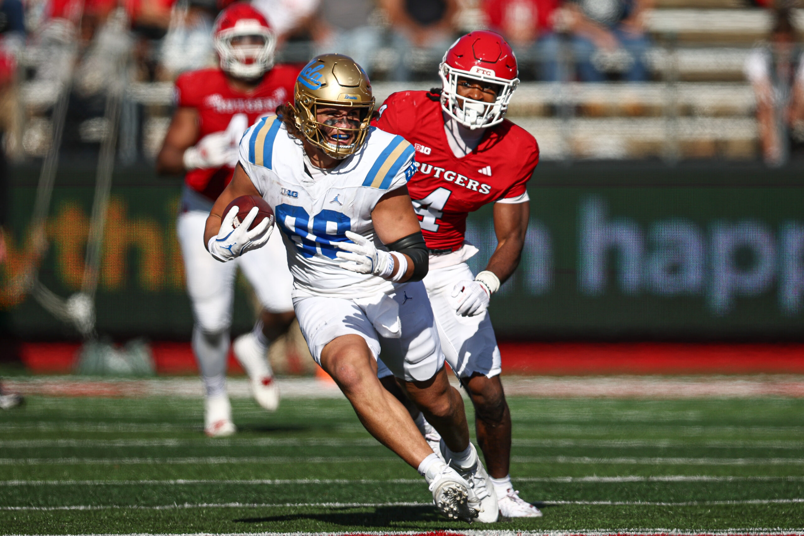 UCLA Bruins tight end Moliki Matavao (88) gains yards after catch as Rutgers Scarlet Knights defensive back Desmond Igbinosun (4) during the second half at SHI Stadium.