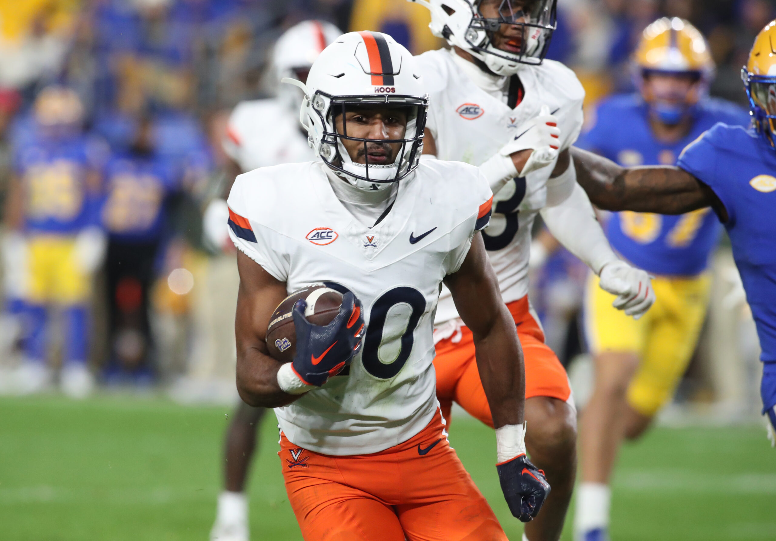 Virginia Cavaliers safety Jonas Sanker (20) returns an interception against the Pittsburgh Panthers during the third quarter at Acrisure Stadium.