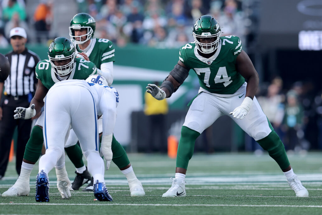 New York Jets offensive tackle Olu Fashanu (74) blocks for quarterback Aaron Rodgers (8) against the Indianapolis Colts at MetLife Stadium.  