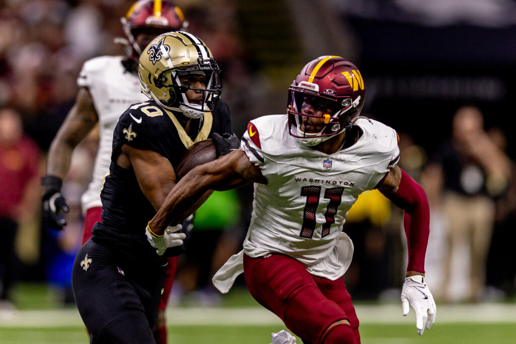 Washington Commanders safety Jeremy Chinn (11) tackles New Orleans Saints wide receiver Marquez Valdes-Scantling (10) during the second half at Caesars Superdome.