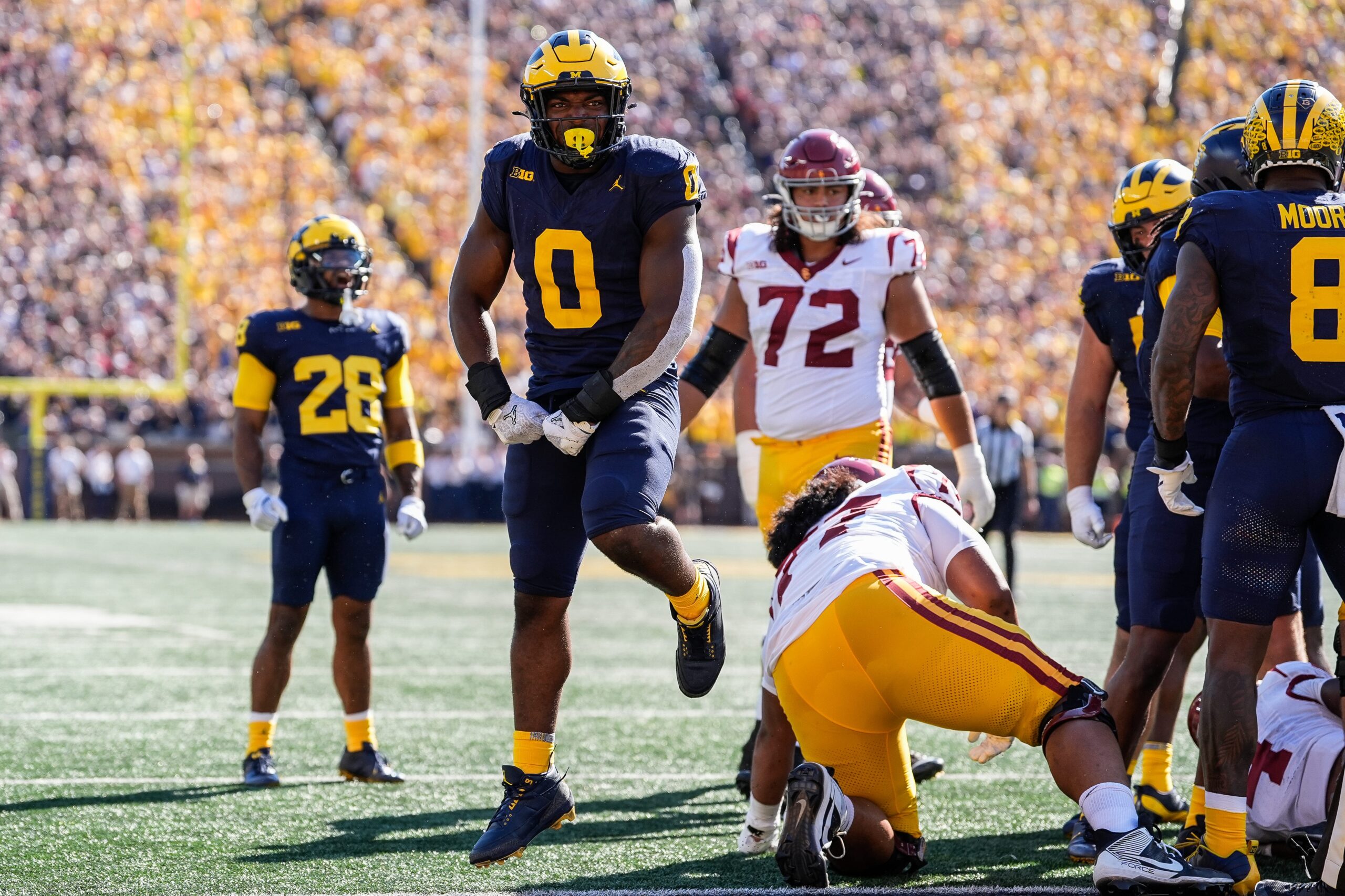 Michigan defensive end Josaiah Stewart (0) celebrates a tackle against USC during the first half at Michigan Stadium in Ann Arbor.