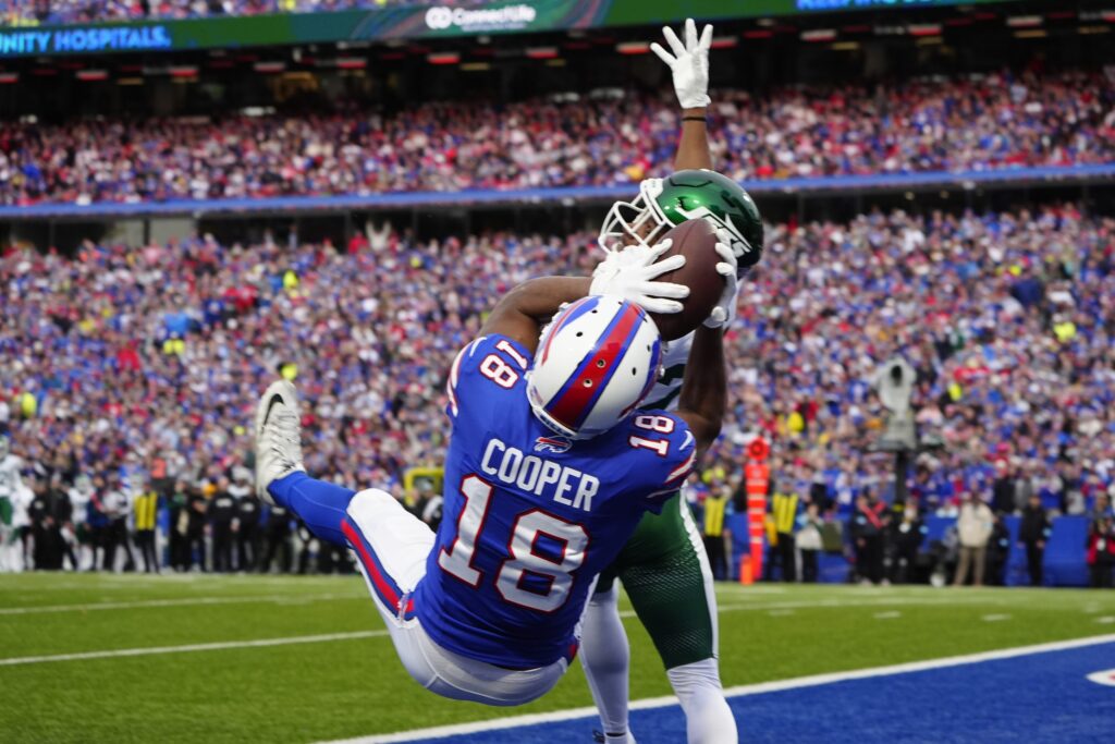 Buffalo Bills wide receiver Amari Cooper (18) makes a catch for a touchdown against New York Jets cornerback Brandin Echols (26) during the second half at Highmark Stadium.