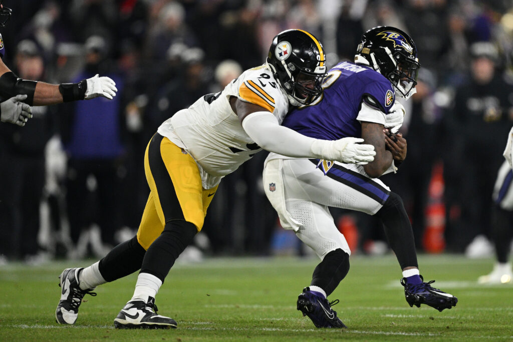 Pittsburgh Steelers defensive tackle Keeanu Benton (95) tackles Baltimore Ravens quarterback Lamar Jackson (8) in the first quarter in an AFC wild card game at M&T Bank Stadium.