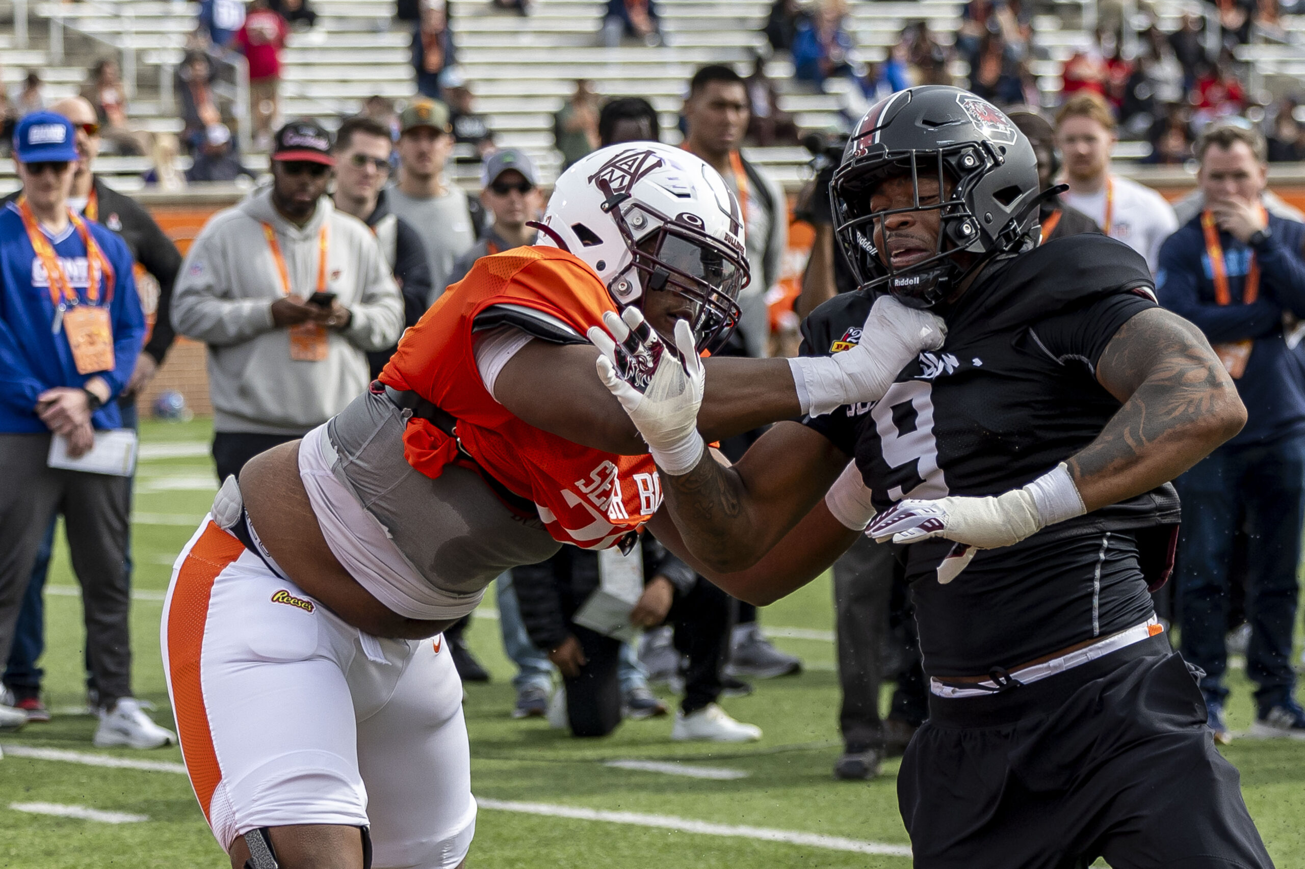 American team offensive lineman Carson Vinson of Alabama A&M (76) spars with American team defensive lineman Kyle Kennard of South Carolina (9) during Senior Bowl practice for the American team.