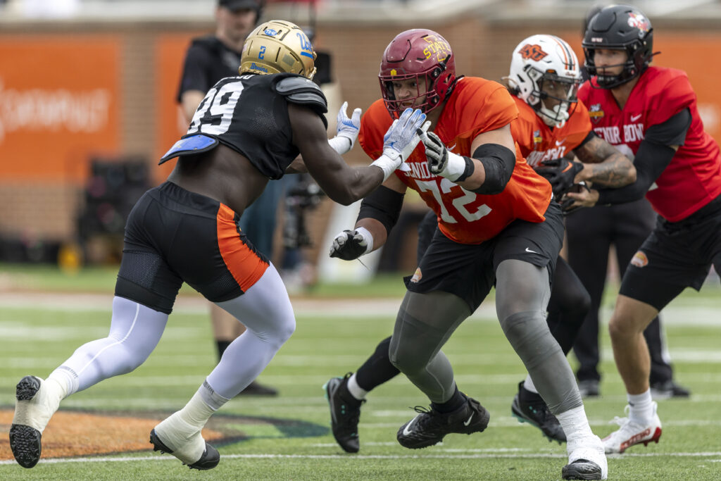 National team defensive lineman Oluwafemi Oladejo of UCLA (99) and National team offensive lineman Jalen Travis of Iowa State (72) work through drills during Senior Bowl practice. 