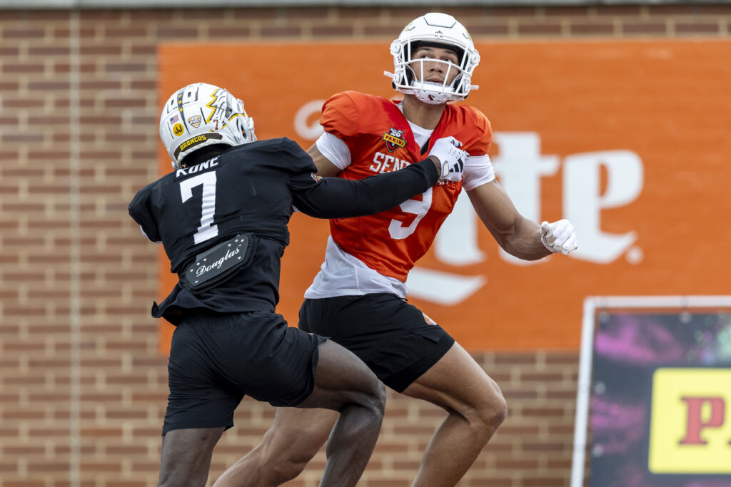 National team wide receiver Jayden Higgins of Iowa State (9) tracks a pass with National team defensive back Bilhal Kone of Western Michigan (7) defending the play during Senior Bowl practice. 